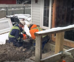 Image of Shield Foundation Repair worker working outside in winter.