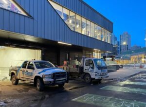 Image of Shield Foundation Repair vehicles outside a building.
