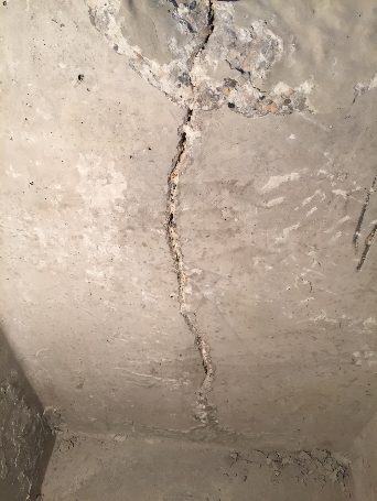Vertical crack running through a poured concrete basement wall