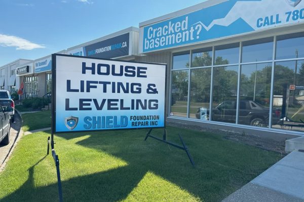 Image of Shield Foundation Repair office with "House Lifting" sign outside.